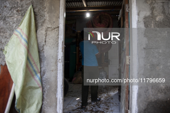 Residents clean their homes and try to save the remaining belongings after a flash flood hits Mekarbuana village, Karawang district, West Ja...