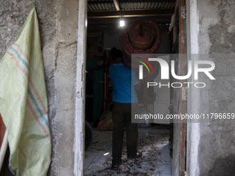 Residents clean their homes and try to save the remaining belongings after a flash flood hits Mekarbuana village, Karawang district, West Ja...