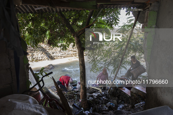 Residents clean their homes and try to save the remaining belongings after a flash flood hits Mekarbuana village, Karawang district, West Ja...