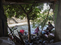 Residents clean their homes and try to save the remaining belongings after a flash flood hits Mekarbuana village, Karawang district, West Ja...