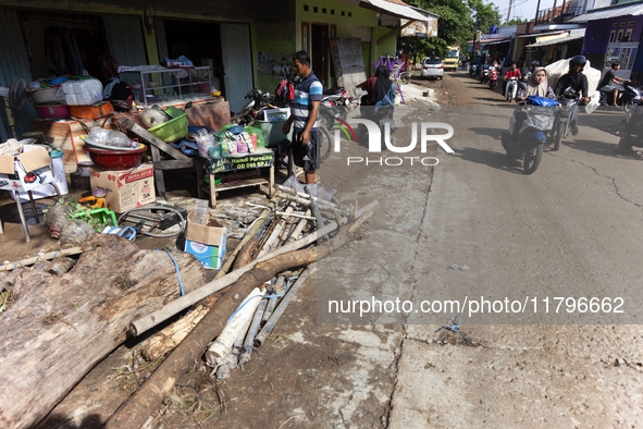 Residents clean their homes and try to save the remaining belongings after a flash flood hits Mekarbuana village, Karawang district, West Ja...