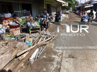 Residents clean their homes and try to save the remaining belongings after a flash flood hits Mekarbuana village, Karawang district, West Ja...