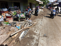 Residents clean their homes and try to save the remaining belongings after a flash flood hits Mekarbuana village, Karawang district, West Ja...