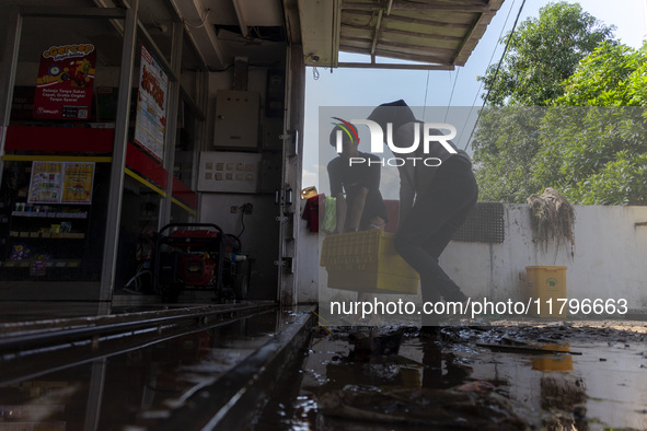 Residents clean their homes and try to save the remaining belongings after a flash flood hits Mekarbuana village, Karawang district, West Ja...