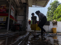 Residents clean their homes and try to save the remaining belongings after a flash flood hits Mekarbuana village, Karawang district, West Ja...