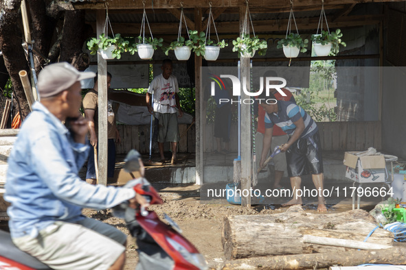 Residents clean their homes and try to save the remaining belongings after a flash flood hits Mekarbuana village, Karawang district, West Ja...