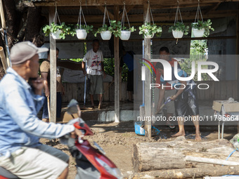 Residents clean their homes and try to save the remaining belongings after a flash flood hits Mekarbuana village, Karawang district, West Ja...