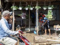 Residents clean their homes and try to save the remaining belongings after a flash flood hits Mekarbuana village, Karawang district, West Ja...