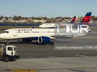 Delta Air Lines Airbus A220-300 passenger aircraft spotted taxiing on the runway and taxiway of LaGuardia airport in NYC with a Boeing 737 o...