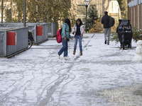 Kids play with the snow after building a snowman. First winter weather of the season with snow hit the Netherlands. Low temperatures with we...