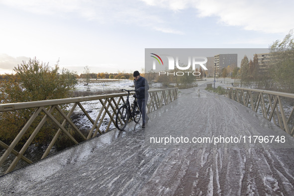 People spotted on their bicycle during with the snow around them. First winter weather of the season with snow hit the Netherlands. Low temp...