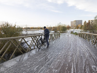 People spotted on their bicycle during with the snow around them. First winter weather of the season with snow hit the Netherlands. Low temp...