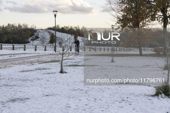 People spotted on their bicycle during with the snow around them. First winter weather of the season with snow hit the Netherlands. Low temp...