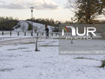 People spotted on their bicycle during with the snow around them. First winter weather of the season with snow hit the Netherlands. Low temp...