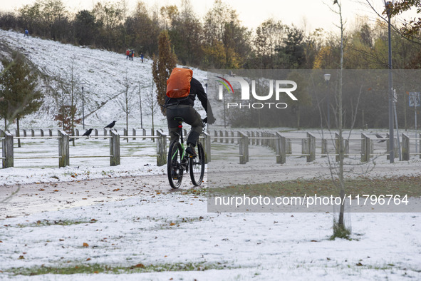 People spotted on their bicycle during with the snow around them. First winter weather of the season with snow hit the Netherlands. Low temp...