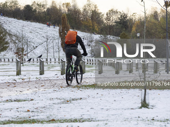 People spotted on their bicycle during with the snow around them. First winter weather of the season with snow hit the Netherlands. Low temp...