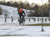 People spotted on their bicycle during with the snow around them. First winter weather of the season with snow hit the Netherlands. Low temp...