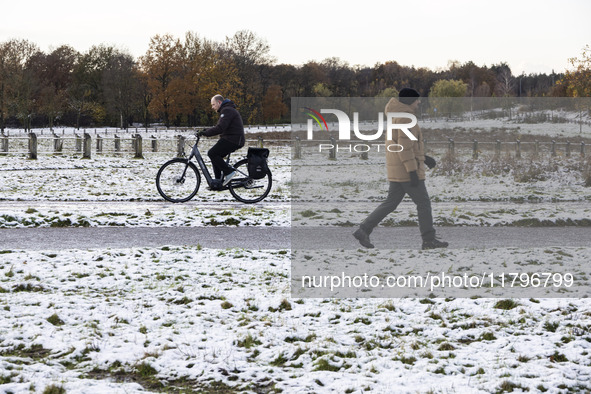 People spotted on their bicycle during with the snow around them. First winter weather of the season with snow hit the Netherlands. Low temp...