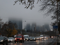 Vehicles make their way along Bloor Street East in foggy weather in Toronto, Ontario, on November 20, 2024. (