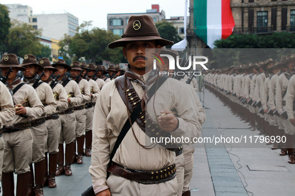 Members of the Mexican armed forces, dressed in attire from the era of the Mexican Revolution, pose before the parade for the 114th annivers...