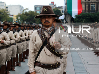 Members of the Mexican armed forces, dressed in attire from the era of the Mexican Revolution, pose before the parade for the 114th annivers...