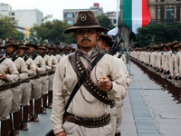 Members of the Mexican armed forces, dressed in attire from the era of the Mexican Revolution, pose before the parade for the 114th annivers...