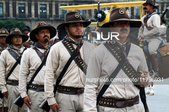 Members of the Mexican armed forces, dressed in attire from the era of the Mexican Revolution, pose before the parade for the 114th annivers...