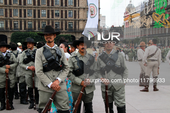 Members of the Mexican armed forces, dressed in attire from the era of the Mexican Revolution, pose before the parade for the 114th annivers...