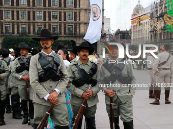 Members of the Mexican armed forces, dressed in attire from the era of the Mexican Revolution, pose before the parade for the 114th annivers...