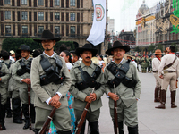 Members of the Mexican armed forces, dressed in attire from the era of the Mexican Revolution, pose before the parade for the 114th annivers...