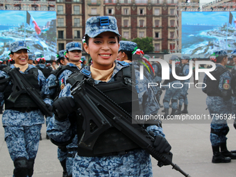 A woman from the Mexican armed forces poses before the parade for the 114th anniversary of the Mexican Revolution at the Zocalo capital in M...