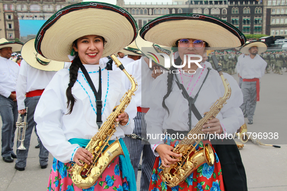 Two women dressed as Adelitas (women who participated in the Mexican Revolution), pose with saxophones before the parade on the occasion of...