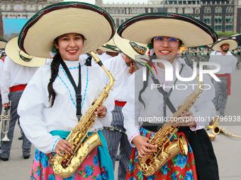 Two women dressed as Adelitas (women who participated in the Mexican Revolution), pose with saxophones before the parade on the occasion of...