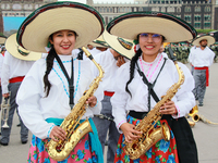 Two women dressed as Adelitas (women who participated in the Mexican Revolution), pose with saxophones before the parade on the occasion of...