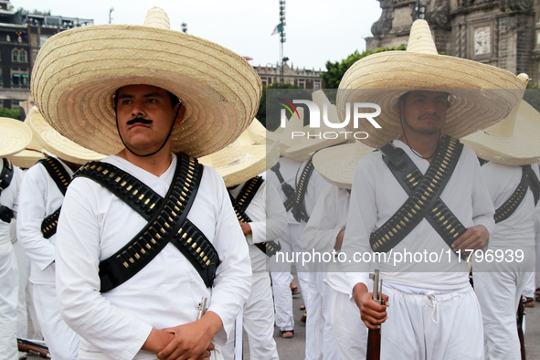 Members of the Mexican armed forces, dressed in attire from the era of the Mexican Revolution, pose before the parade for the 114th annivers...