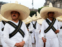 Members of the Mexican armed forces, dressed in attire from the era of the Mexican Revolution, pose before the parade for the 114th annivers...