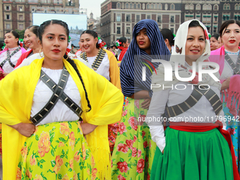 Women dressed as Adelitas, who participate in the Mexican Revolution, are seen before the parade on the occasion of the 114th anniversary of...