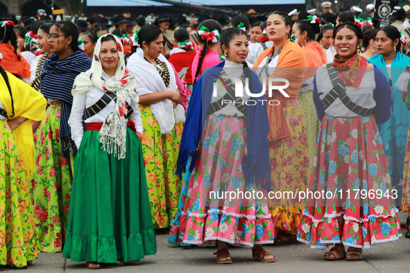 Women dressed as Adelitas, who participate in the Mexican Revolution, are seen before the parade on the occasion of the 114th anniversary of...