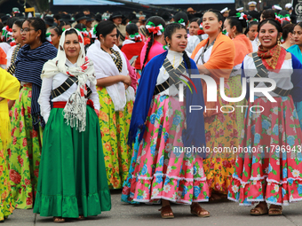 Women dressed as Adelitas, who participate in the Mexican Revolution, are seen before the parade on the occasion of the 114th anniversary of...