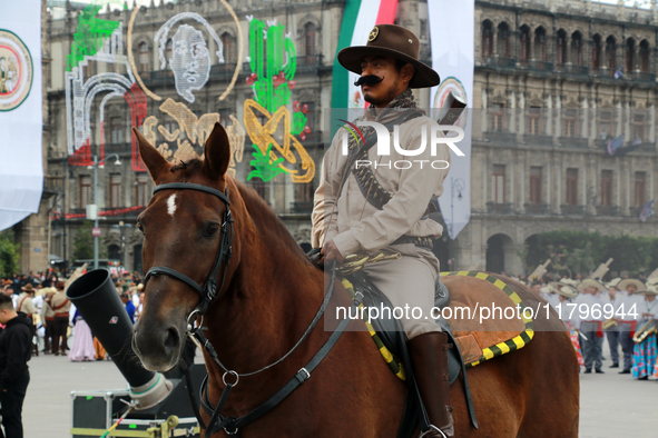 A member of the Mexican armed forces, dressed in attire from the time of the Mexican Revolution and riding a horse, is seen before the parad...