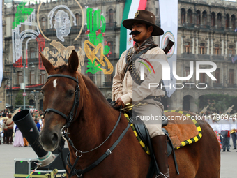 A member of the Mexican armed forces, dressed in attire from the time of the Mexican Revolution and riding a horse, is seen before the parad...