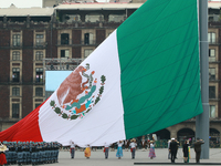 The Mexican flag is raised before the civic parade for the 114th anniversary of the Mexican Revolution at the Zocalo in Mexico City, Mexico,...