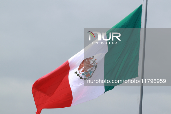 The Mexican flag flies during the parade marking the 114th anniversary of the Mexican Revolution at the Zocalo in Mexico City, Mexico, on No...