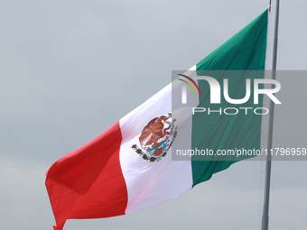 The Mexican flag flies during the parade marking the 114th anniversary of the Mexican Revolution at the Zocalo in Mexico City, Mexico, on No...