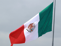 The Mexican flag flies during the parade marking the 114th anniversary of the Mexican Revolution at the Zocalo in Mexico City, Mexico, on No...