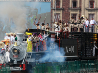 Members of the armed forces, dressed in attire from the time of the Mexican Revolution, stage a scene from the Mexican Revolution on a repli...