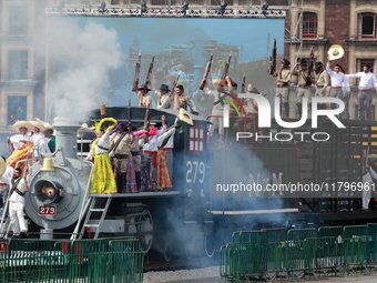 Members of the armed forces, dressed in attire from the time of the Mexican Revolution, stage a scene from the Mexican Revolution on a repli...