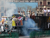 Members of the armed forces, dressed in attire from the time of the Mexican Revolution, stage a scene from the Mexican Revolution on a repli...