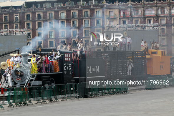 Members of the armed forces, dressed in attire from the time of the Mexican Revolution, stage a scene from the Mexican Revolution on a repli...