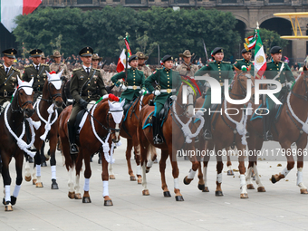 Members of the Mexican armed forces, mounted on horses, take part in the parade marking the 114th anniversary of the Mexican Revolution at t...